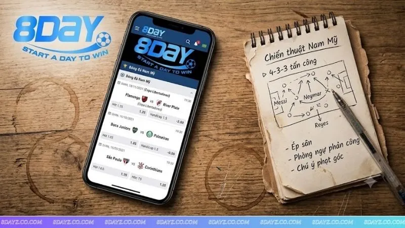 Điện thoại hiển thị tỷ lệ bóng đá trên 8DAY bên cạnh cuốn sổ ghi chép mẹo soi kèo bóng đá đêm khuya thực chiến.